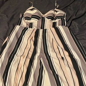 One piece, Jump suit, pockets, long pant legs. Colors light pink, white, black.